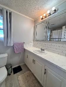 Well-Maintained Mobile Home with Fenced Yard - Photo 10