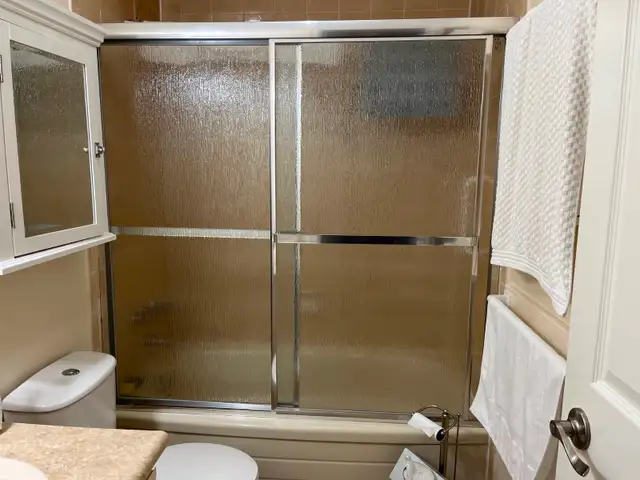 CHROME, FRAMED BATHTUB SLIDING DOORS - RAIN DROP GLASS DESIGN