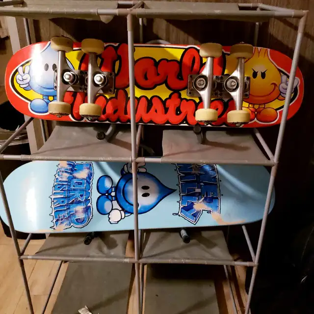 2 skateboards by World Industries with shelfs