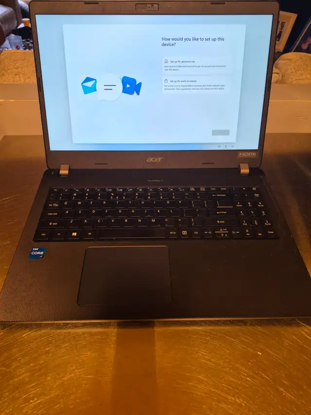 Laptop, gaming headphones and wheeled computer case