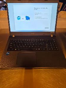 Laptop, gaming headphones and wheeled computer case