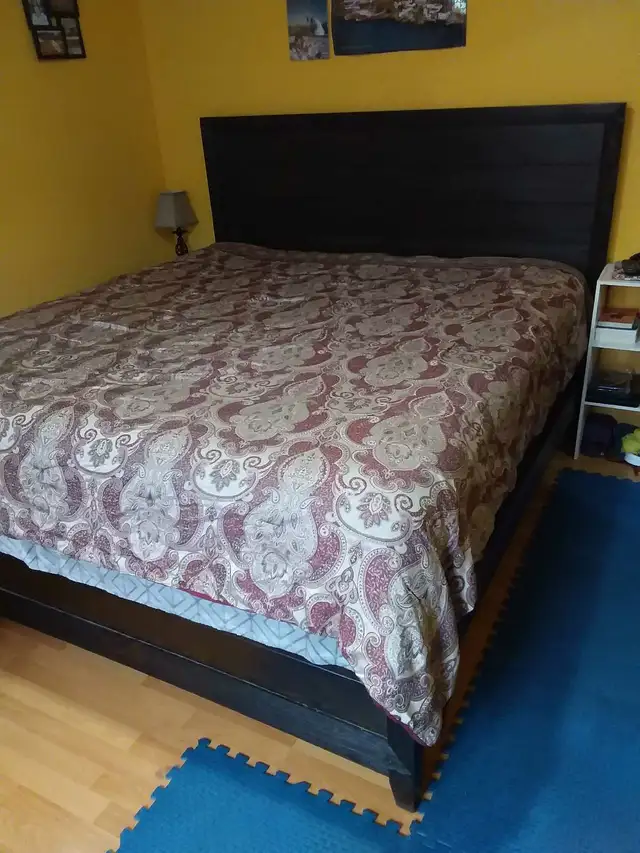 Newer king sized bed with mattress, box spring, and back board.