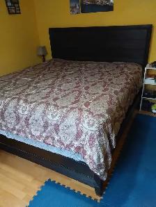 Newer king sized bed with mattress, box spring, and back board.