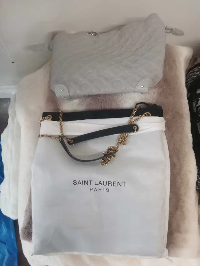 Two purses have wallets as well