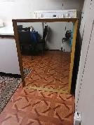 Wooden framed mirror hangs up