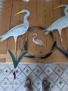 Two blue flamingos and one smaller pink one