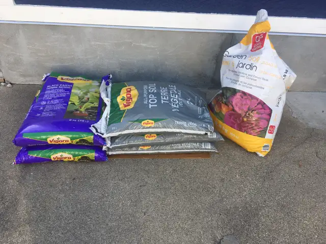 Six bags of soil and planters of soil - $15 for the lot