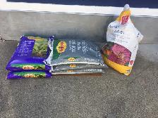 Six bags of soil and planters of soil - $15 for the lot